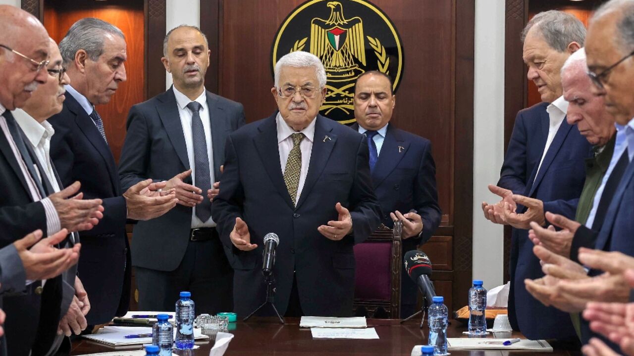 A handout picture released by the Palestinian Authority shows President Mahmud Abbas (C) leading prayers next to Hussein al-Sheikh (3rd-L) during a meeting of the organisation's Executive Committee in Ramallah