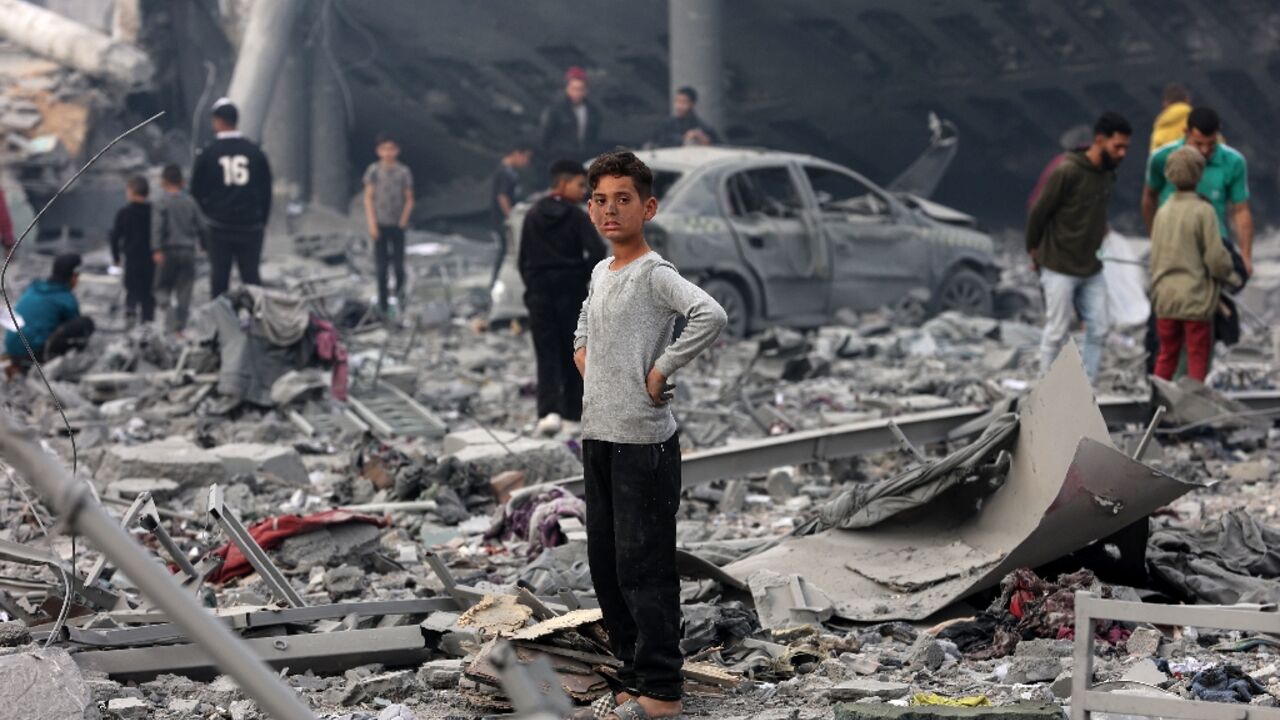 A young Palestinian boy stands amid the rubble of a school building in the Al-Tuffa neighbourhood of Gaza where rescuers say at least 31 people were killed in an Israeli strike on Thursday.