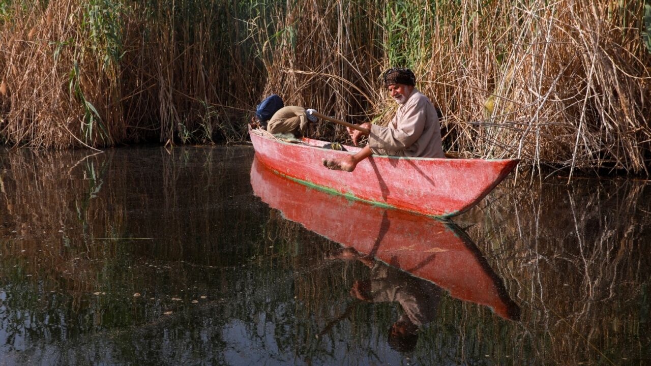 A fisherman on Iraq's receding marshes that straddle the border with Iran