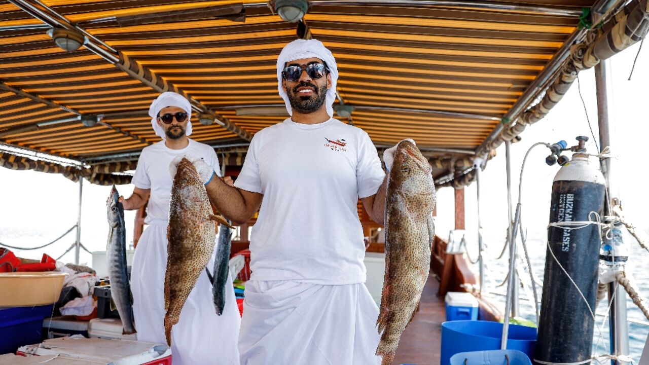 A Qatari contestant shows off his catch in a line-fishing competition that forms part of a festival aimed at reviving the emirate's sea-faring tradition.
