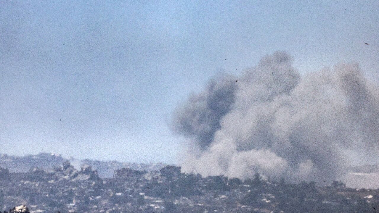 Smoke billows over destroyed buildings during an Israeli bombardment in Gaza on Friday 