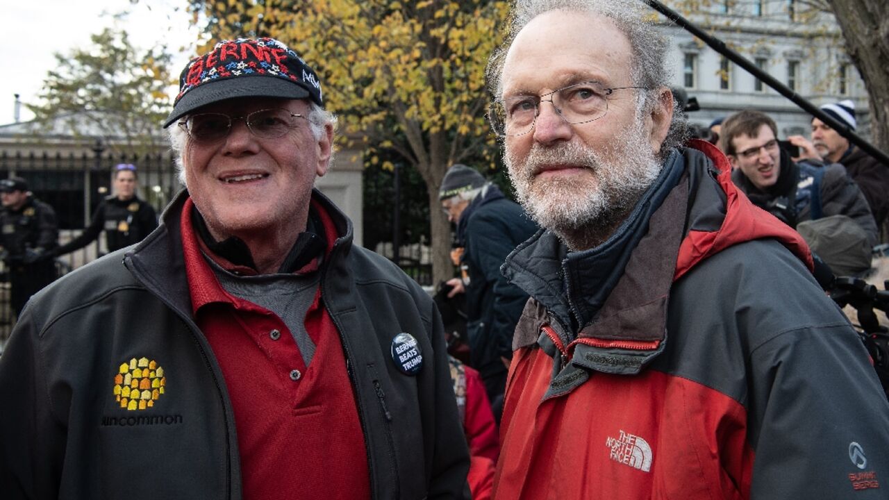 Ben Cohen (L) and Jerry Greenfield, the founders of Ben and Jerry's ice cream, stand outside the White House during a climate rally in Washington, DC on November 8, 2019