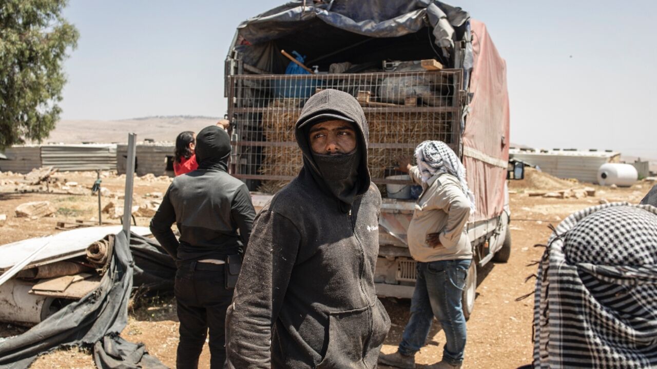 Men load a truck with their belongings in Maghayer al-Deir, east of Ramallah in the occupied West Bank
