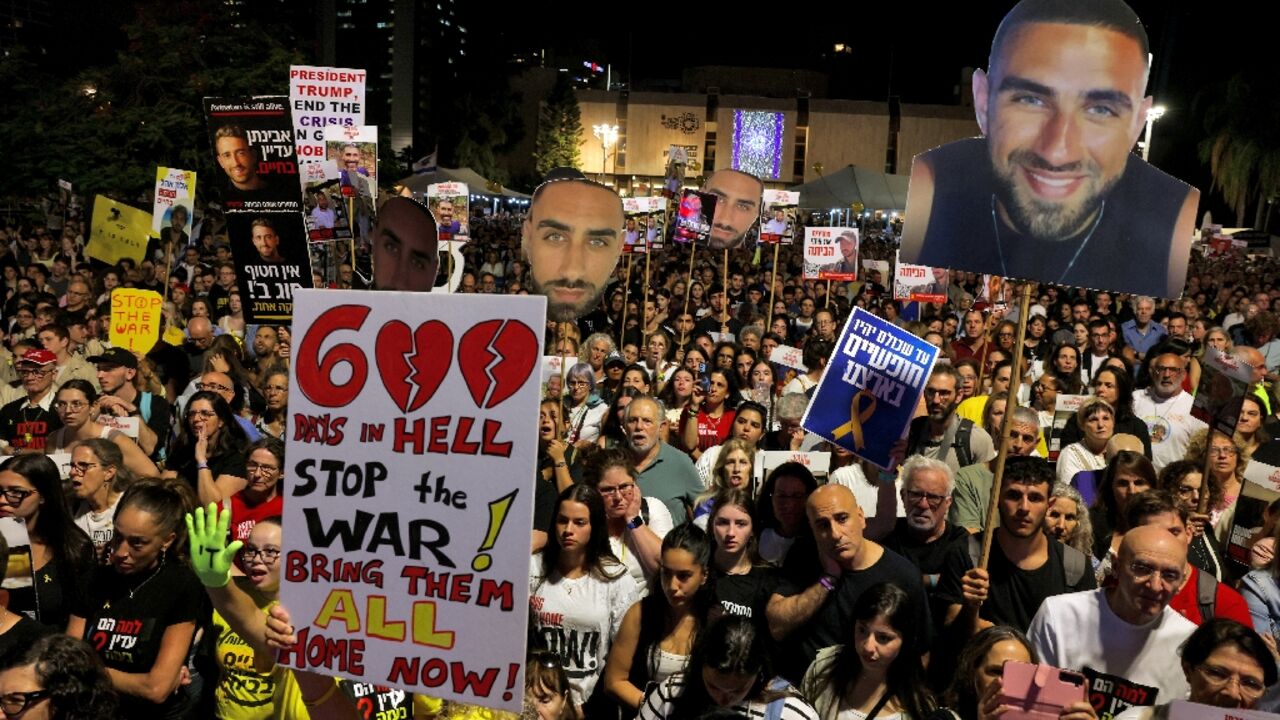 Relatives and supporters of hostages held in Gaza since October 7 hold their portraits during a protest at Hostages Square in Tel Aviv