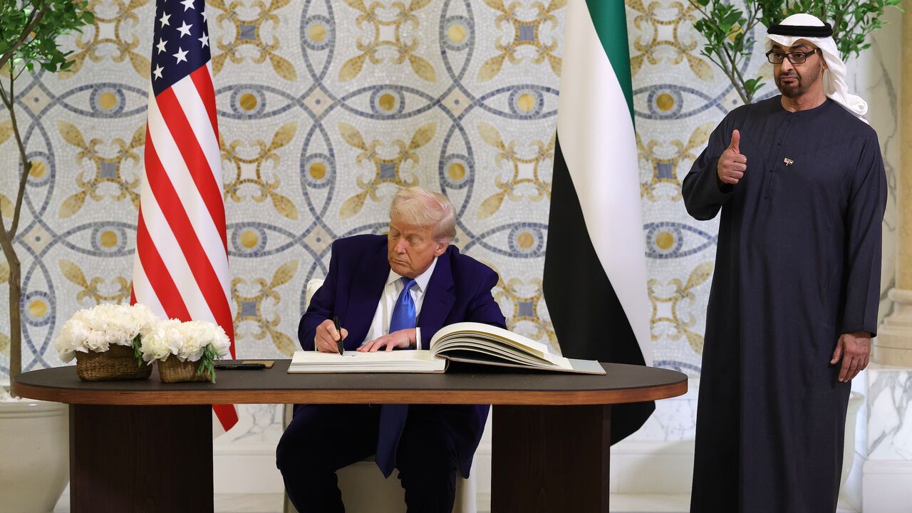 US President Donald J. Trump signs the guestbook as UAE President Sheikh Mohamed bin Zayed Al Nahyan looks on.
