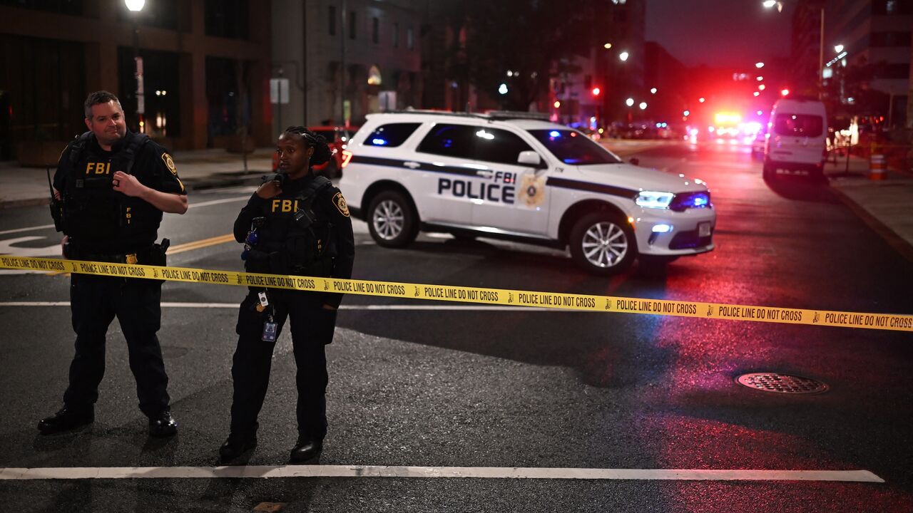 FBI agents cordon off the scene outside the Capital Jewish Museum following a shooting that left two people dead, in Washington, DC, in the early hours of May 22, 2025.