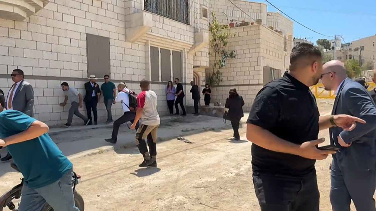 This frame grab from AFPTV footage shows members of a diplomatic delegation from the European Union reacting after shots were fired as they gathered in the eastern entrance of Jenin