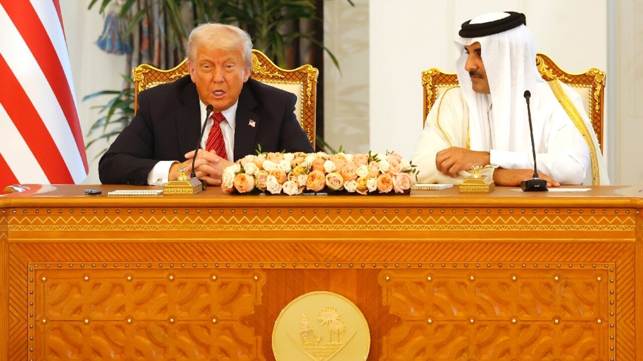 Qatar's Emir Sheikh Tamim bin Hamad al-Thani listens to US President Donald Trump at the Royal Palace in Doha