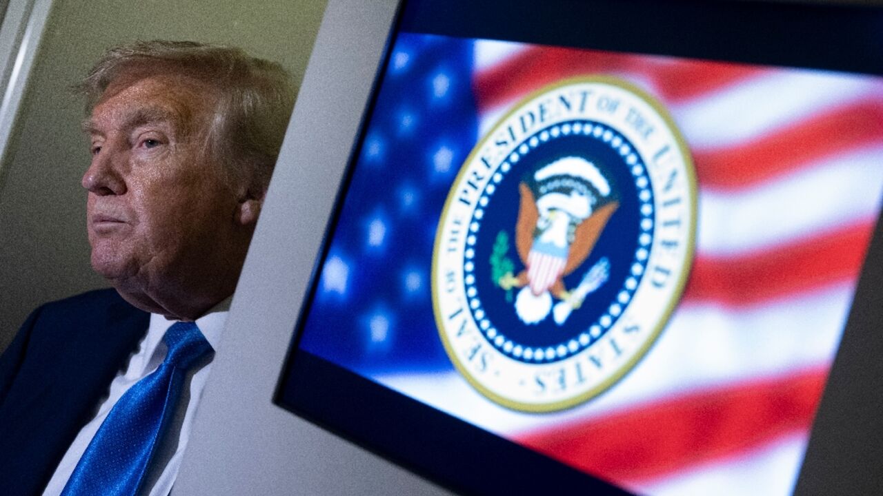 US President Donald Trump speaks to reporters about the G7 Summit aboard Air Force One while travelling back to Washington from Canada