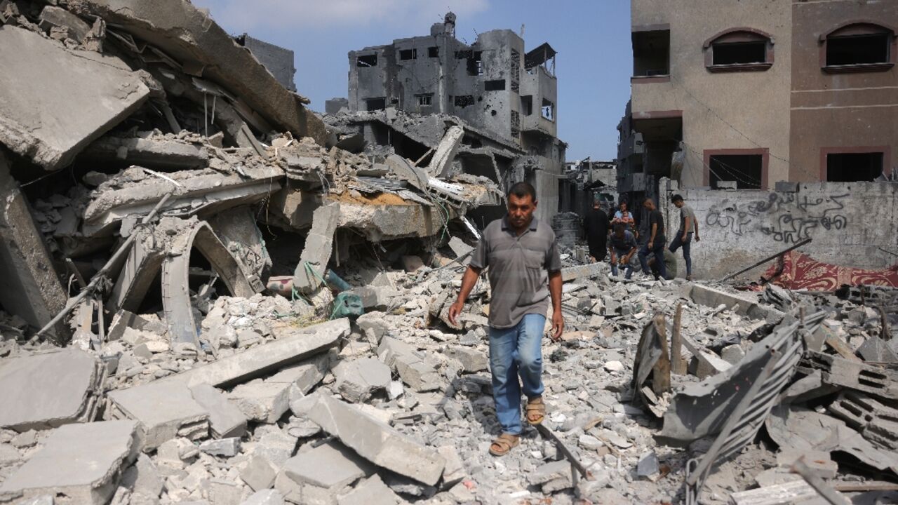 A Palestinian man walks beside the rubble of a house hit by overnight Israeli strikes in Jabalia in the northern Gaza Strip on Monday