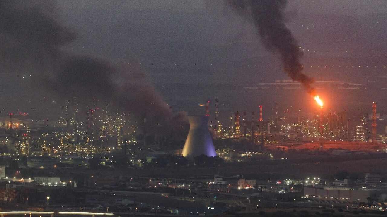 Smoke billows in the skyline of Israeli city of Haifa