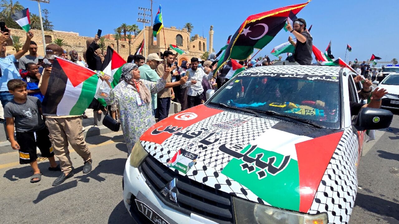 Activists, heading towards Gaza by land with the aim of breaking the siege on the Palestinian territory, are greeted by Libyans in Tripoli's Martyrs Square