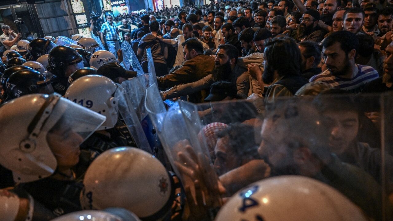 Islamist protesters clash with Turkish anti riot police officers as they gather to protest Leman cartoon magazine in Istanbul on June 30, 2025
