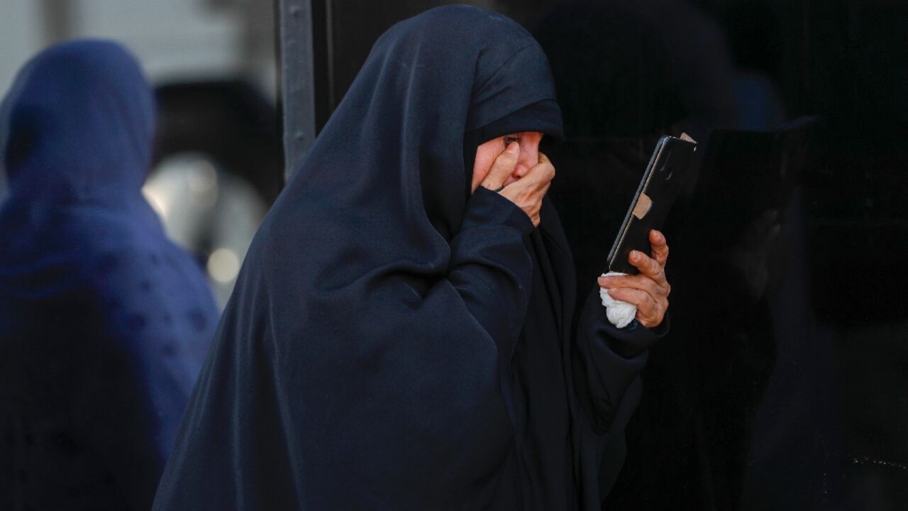 An Iranian woman in the Iraqi town of Ayn Tamr weeps after receiving word that a relative was killed in Israeli strikes back home