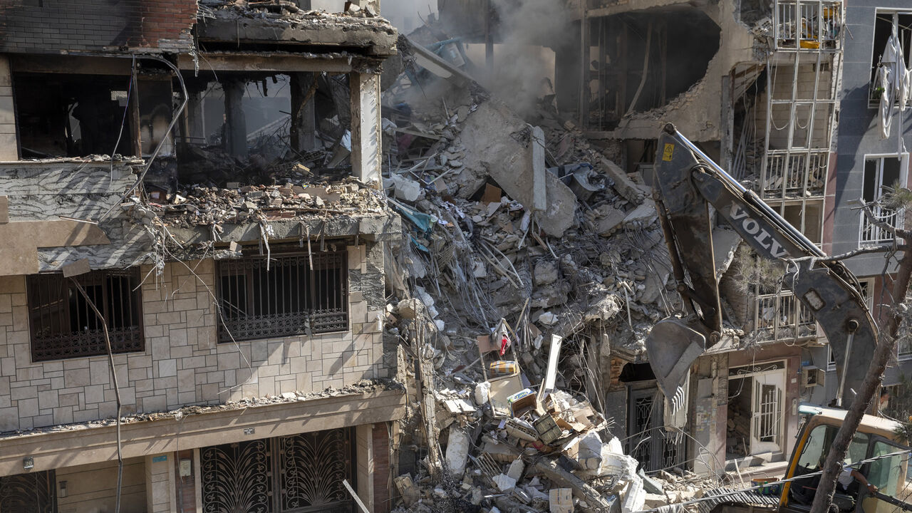 An excavator removes debris from a residential building that was destroyed in today's attack by Israel in Tehran, Iran, June 13, 2025.