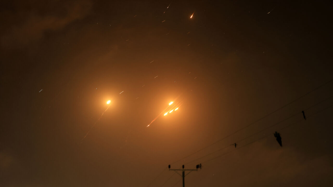 Debris of missiles fired from Iran toward Israel leave trails in the night sky over the Gaza Strip after being intercepted on June 13, 2025. (Photo by AFP) (Photo by -/AFP via Getty Images)
