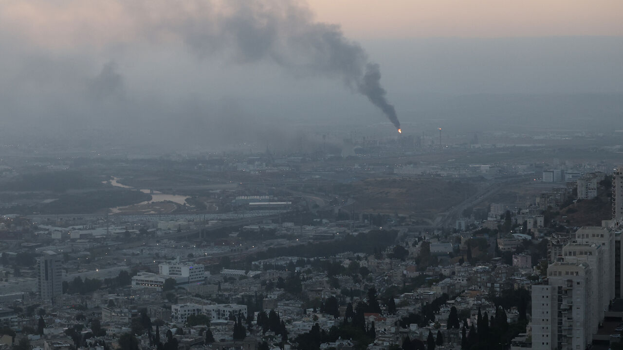 Smoke billows from a site that was hit by an Iranian missile strike in the city of Haifa early on June 16, 2025. 