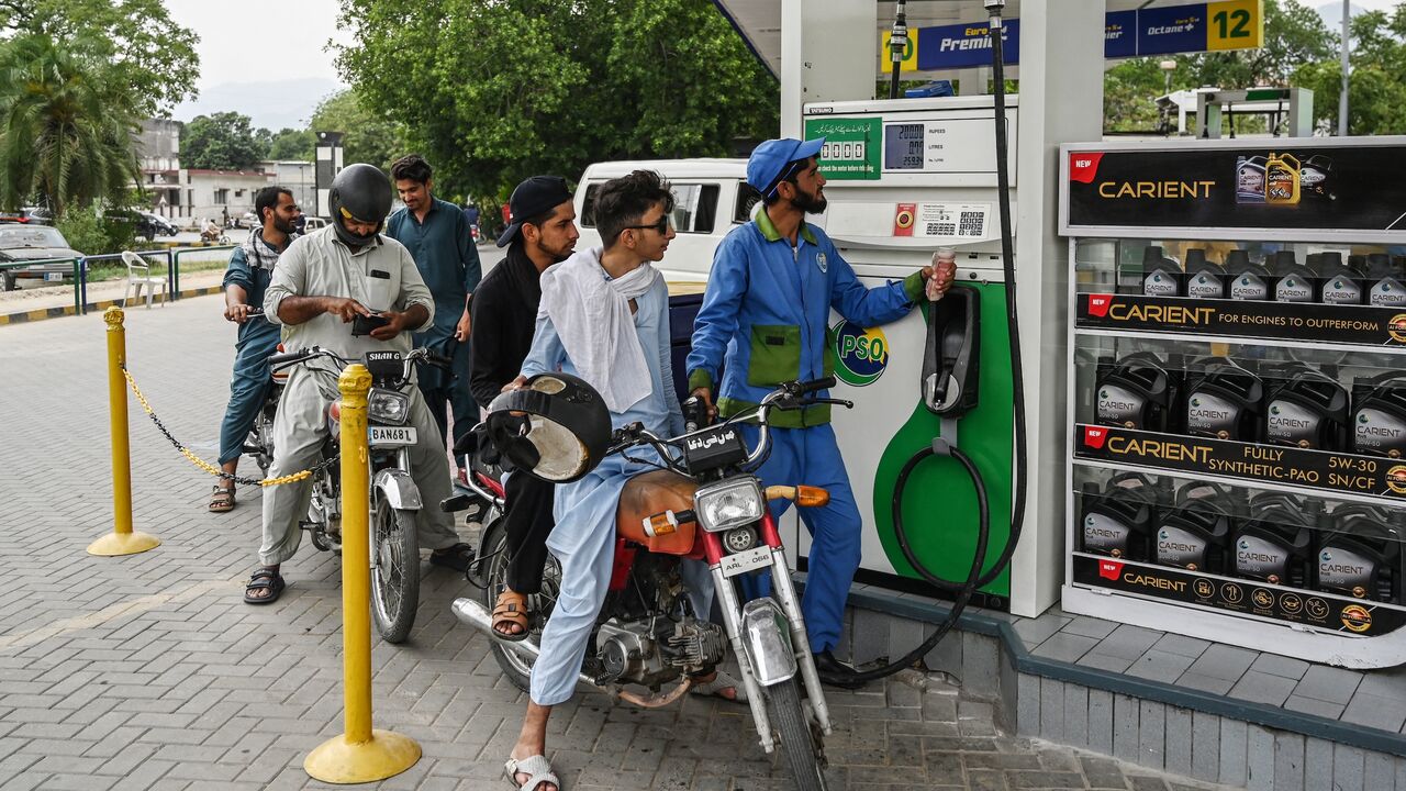 An employee fills the tank of a motorbike at a fuel station in Islamabad, on June 16, 2025.