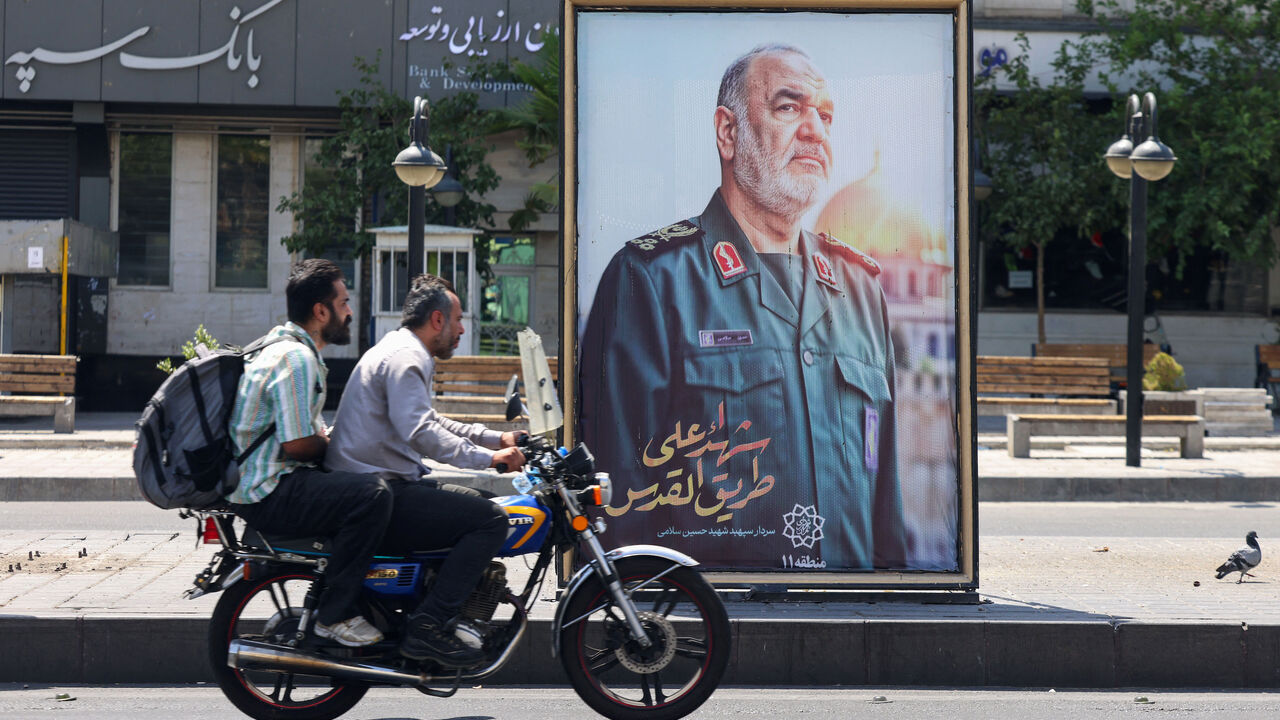 A poster of slain Iranian Islamic Revolutionary Guard Corps (IRGC) commander Hossein Salami, killed following Israeli strikes on targets in Iran, is set up at a Tehran square on June 16, 2025.