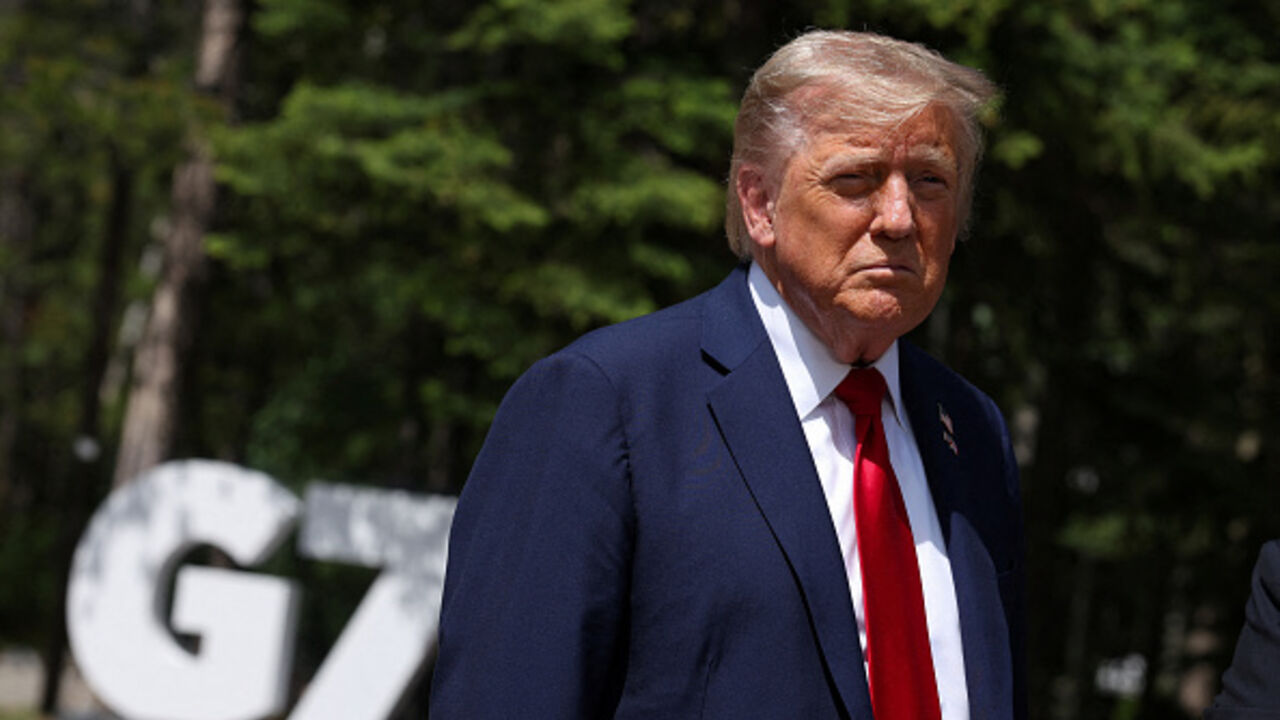 US President Donald Trump speaks to reporters with the British prime minister (out of frame) during the Group of Seven (G7) Summit at the Pomeroy Kananaskis Mountain Lodge in Kananaskis, Alberta, Canada on June 16, 2025. US President Donald Trump was leaving a Group of Seven summit early on Monday as he hinted of greater involvement in the Israel-Iran conflict after issuing an ominous warning for the capital Tehran to evacuate. (Photo by Suzanne Plunkett / POOL / AFP) (Photo by SUZANNE PLUNKETT/POOL/AFP via