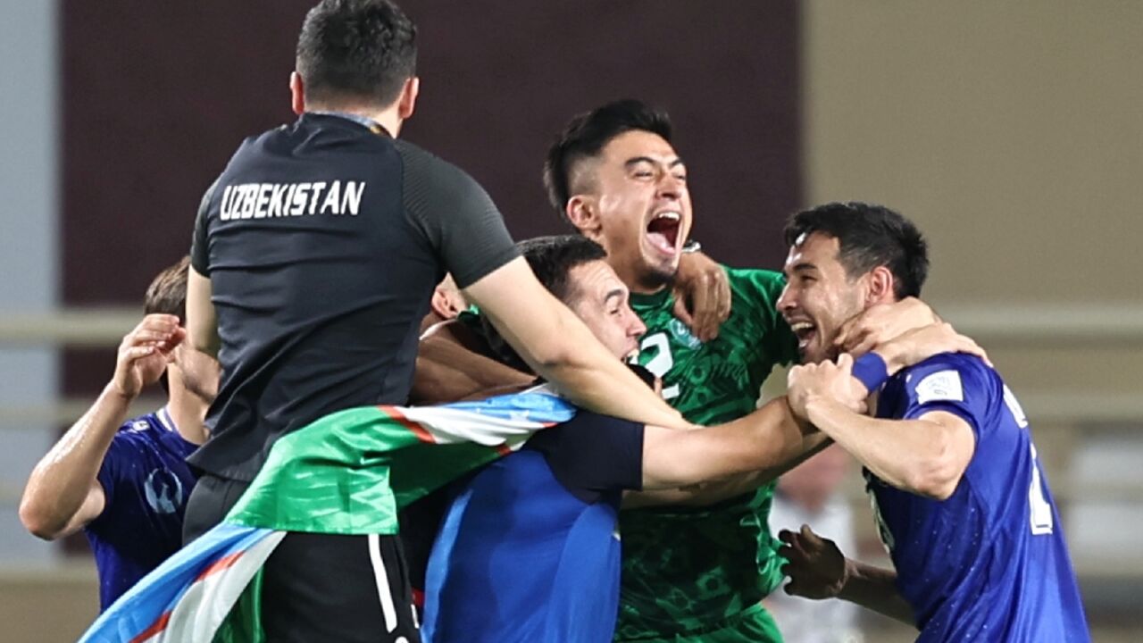 Uzbekistan's players celebrate after qualifying for the World Cup for the first time