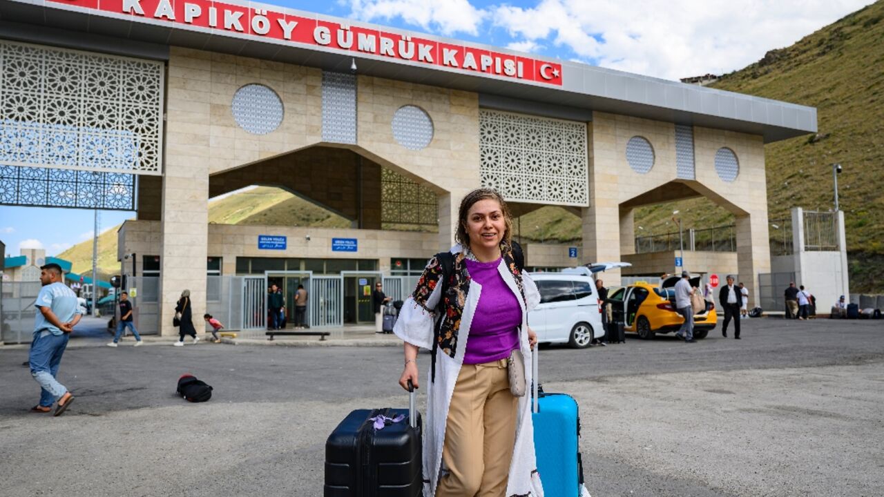 Homa, a 40-year-old Iranian, arrives in Turkey through the Razi-Kapikoy border crossing, north-eastern Turkey on June 18, 2025