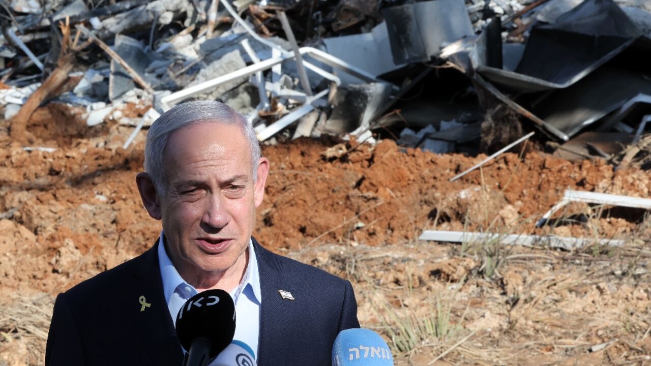 Israel's Prime Minister Benjamin Netanyahu at the site of a missile strike near Tel Aviv