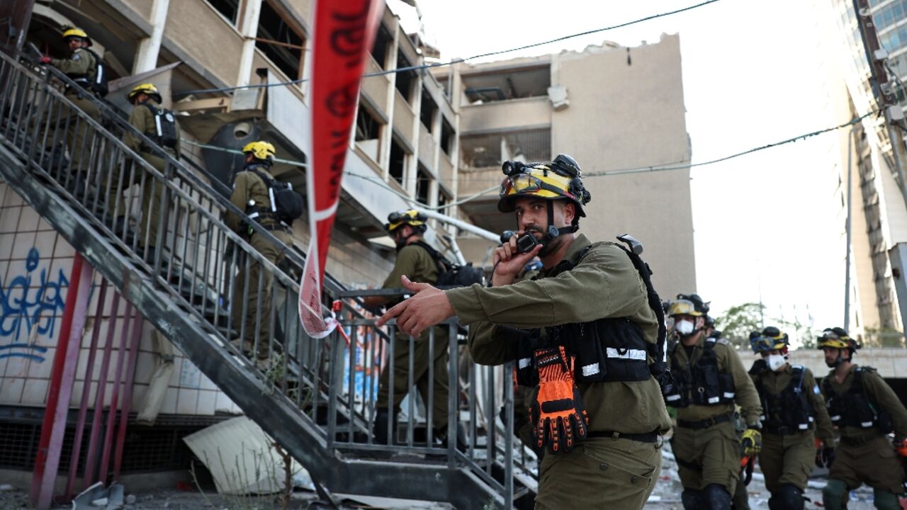 Israeli first responders at the scene of a reported Iranian strike in Haifa