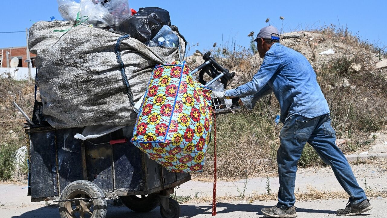 It's common to see people in Tunis weighed down by bags of plastic bottles along the roadside