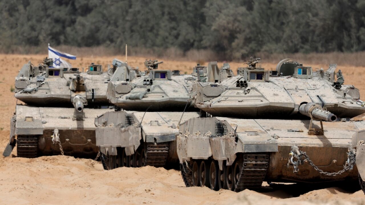 Israeli troops deploy at the border with the Gaza Strip on Tuesday, as the military announced it had expanded its campaign in the territory