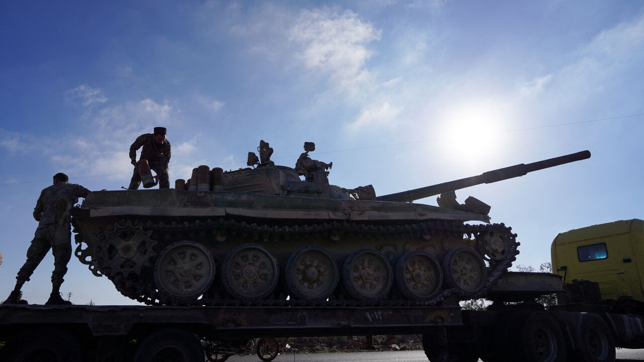 A member of the Syrian security forces stands on a military vehicle after Syrian troops entered the predominantly Druze city of Sweida on Tuesday following two days of clashes, in Sweida, Syria July 15, 2025. REUTERS/Karam al-Masri