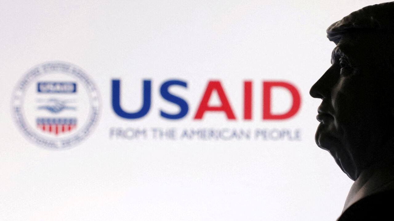 FILE PHOTO: A 3D-printed miniature model of U.S. President Donald Trump with the USAID logo in the background is seen in this illustration taken April 23, 2025. REUTERS/Dado Ruvic/Illustration/File Photo
