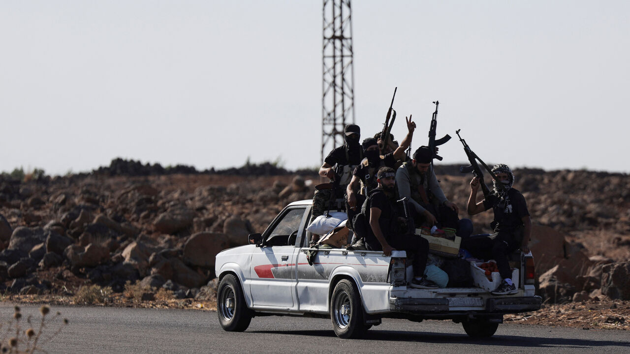 Bedouin fighters ride a car, following renewed fighting between Bedouin fighters and Druze gunmen, despite an announced truce, in Sweida, Syria July 18, 2025. REUTERS/Khalil Ashawi