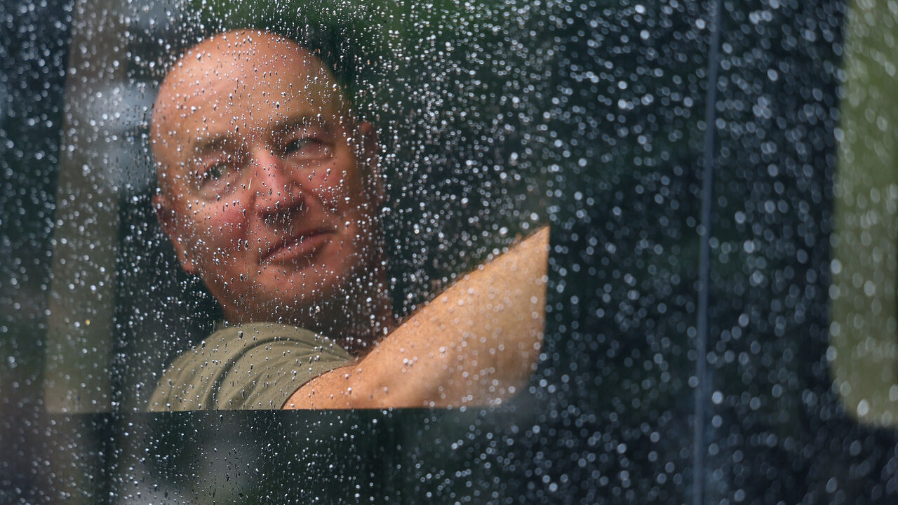 A detained demonstrator sits inside a police van, following a protest in support of the Palestine Action group in Parliament Square in London, Britain, July 19, 2025. REUTERS/Isabel Infantes