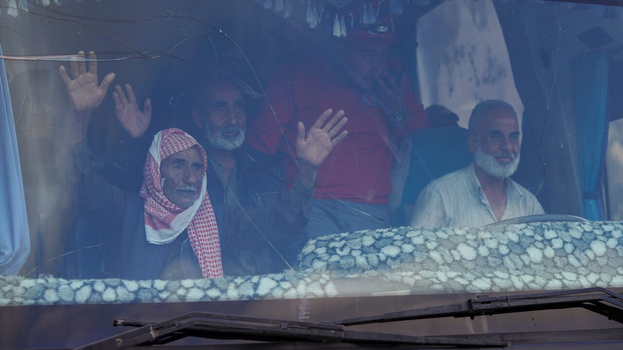 Bedouin families ride in a vehicle as they leave the village of Al-Mazraa, as residents reported calm in Syria's Sweida on Sunday after the Islamist-led government announced that Bedouin fighters had withdrawn from the predominantly Druze city and a U.S. envoy signaled that a deal to end days of fighting was being implemented, in Sweida, Syria, July 21, 2025. REUTERS/Karam al-Masri