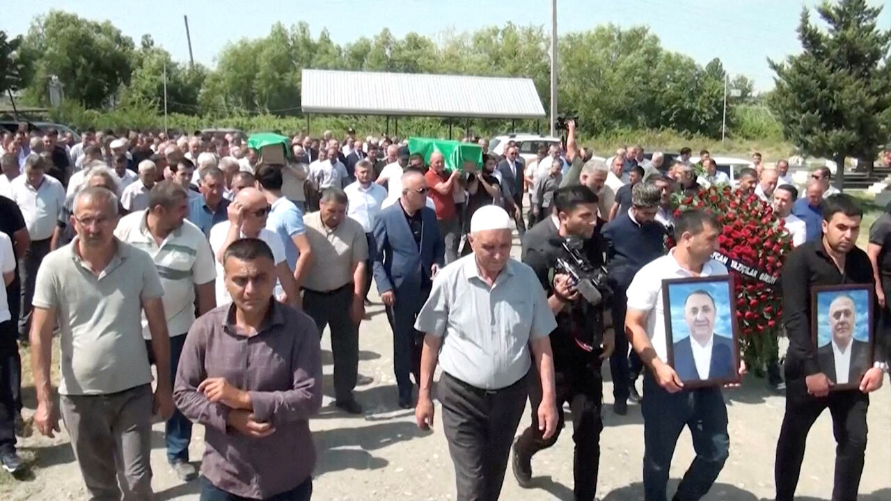 FILE PHOTO: People followed by mourners carry the coffins of Azerbaijani brothers Huseyn and Ziyaddin Safarov, who died in Russian police custody, to a cemetery in Hacibedelli, Azerbaijan, July 1, 2025, in this still image from video. Reuters TV/via REUTERS/File Photo