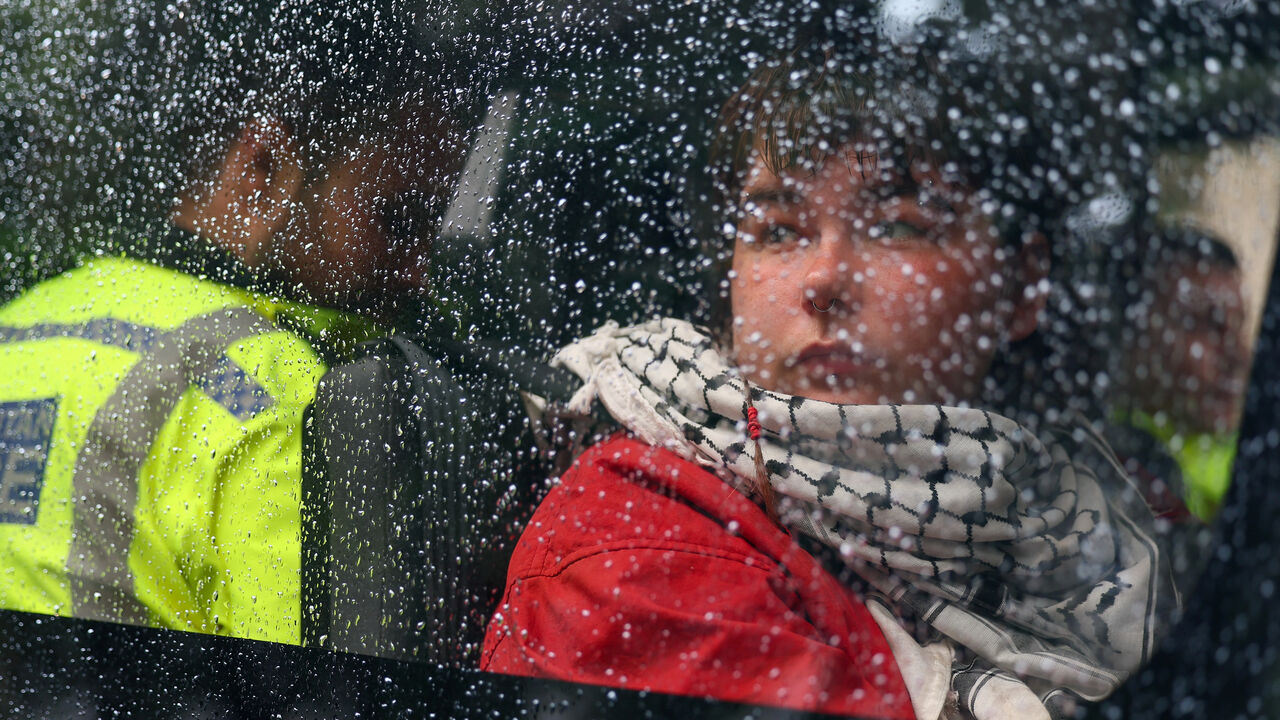 A detained demonstrator sits inside a police van, following a protest in support of the Palestine Action group in Parliament Square in London, Britain, July 19, 2025. REUTERS/Isabel Infantes