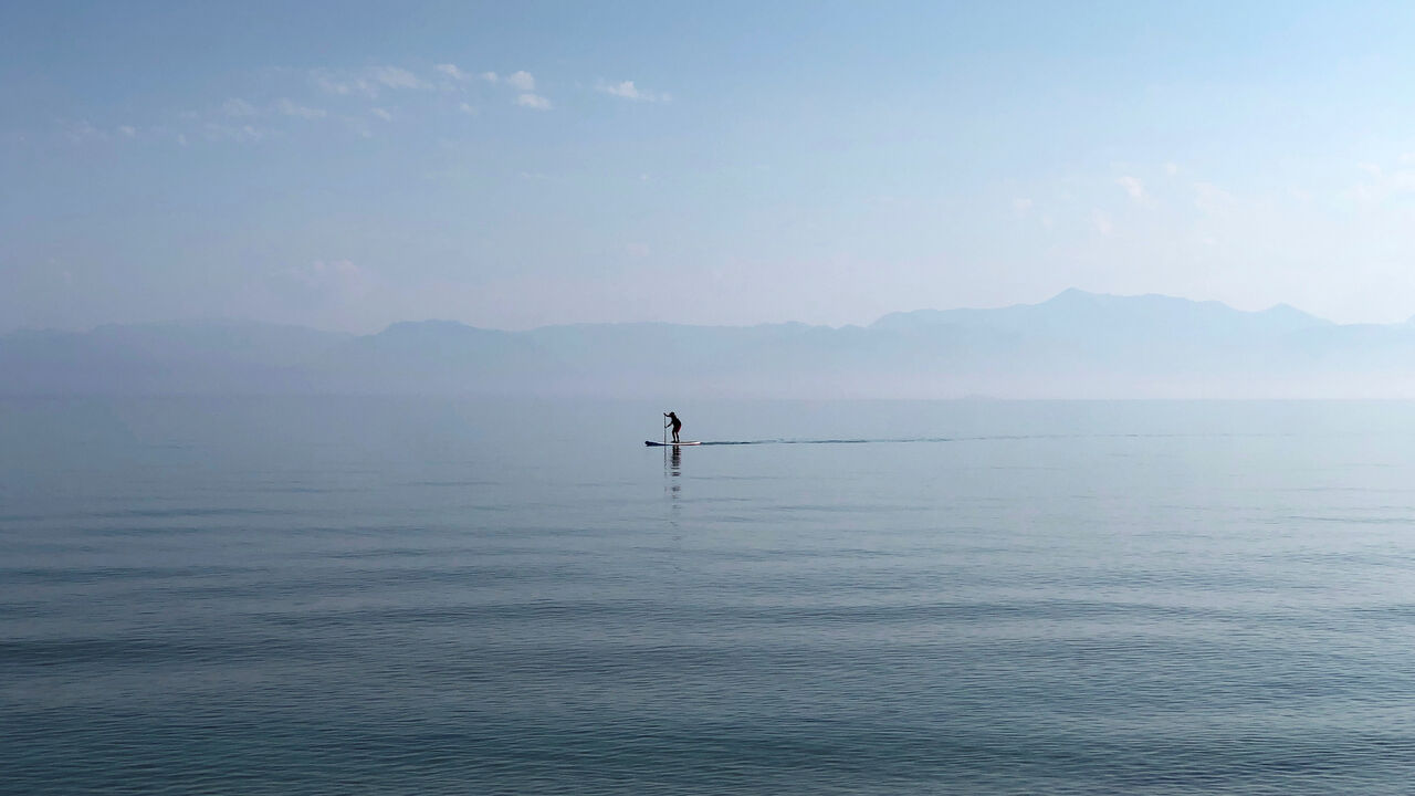 FILE PHOTO: A man paddles in the waters of the Ionian Sea near Sidari settlement on the island of Corfu, Greece July 26, 2019. REUTERS/Vasily Fedosenko/File Photo