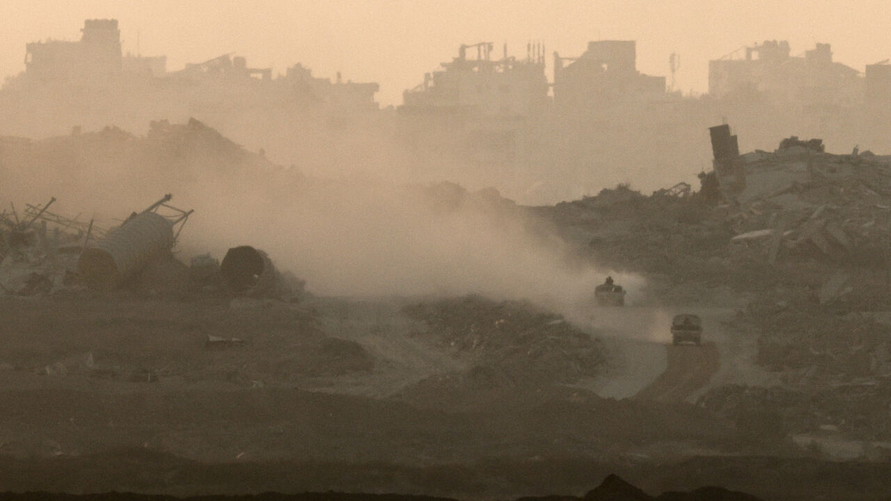Israeli military vehicles manoeuvre in Gaza, as seen from the Israeli side of the Israel-Gaza border, July 21, 2025. REUTERS/Amir Cohen/File Photo