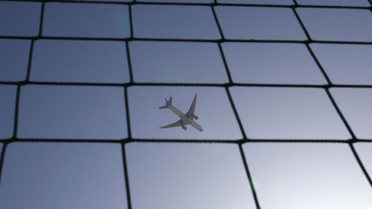 A Qatar Airways plane flies over Dubai, United Arab Emirates, August 20, 2023. REUTERS/Amr Alfiky/File Photo