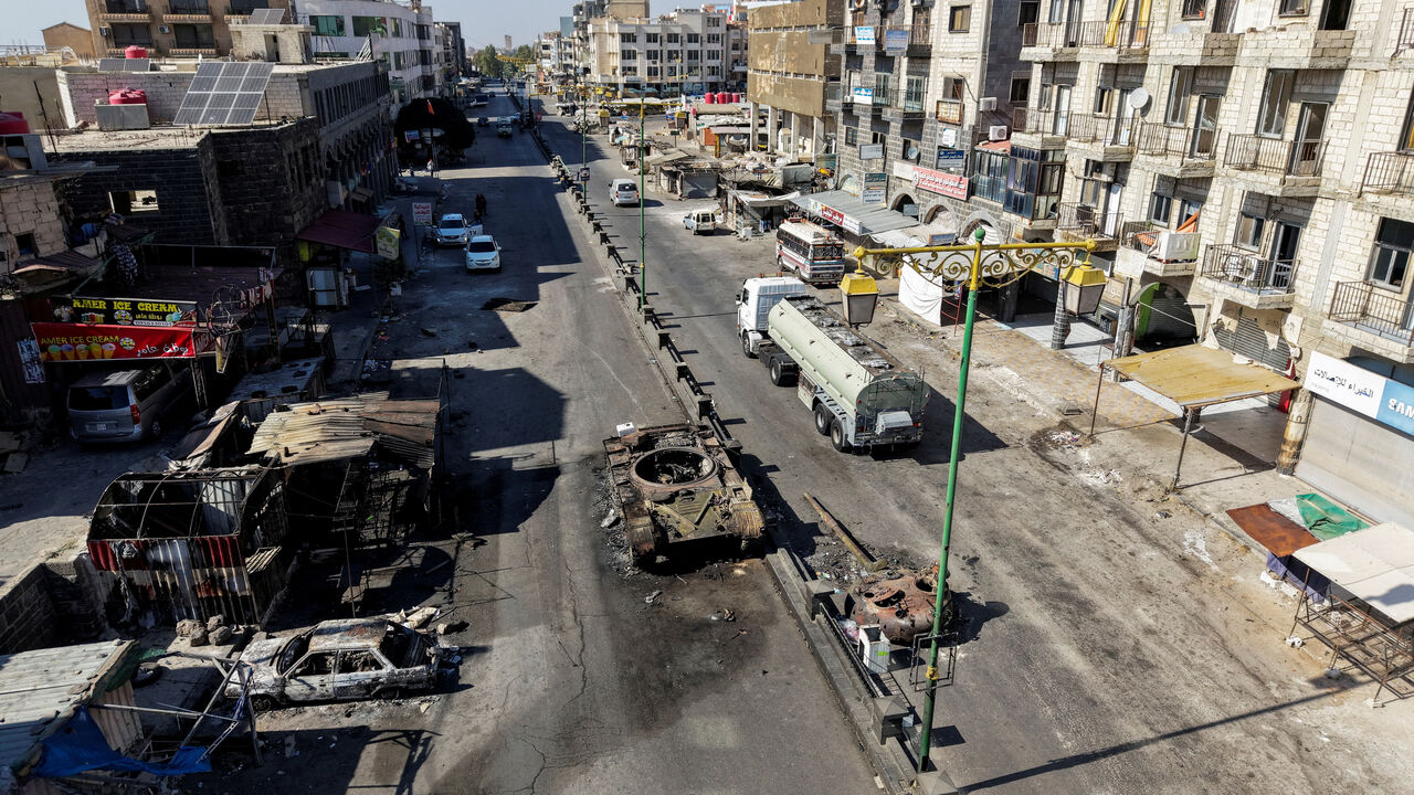 A drone view shows the remains of a destroyed tank, following deadly clashes between Druze fighters, Sunni Bedouin tribes and government forces, in Syria's predominantly Druze city of Sweida, Syria July 25, 2025. REUTERS/Khalil Ashawi/File Photo