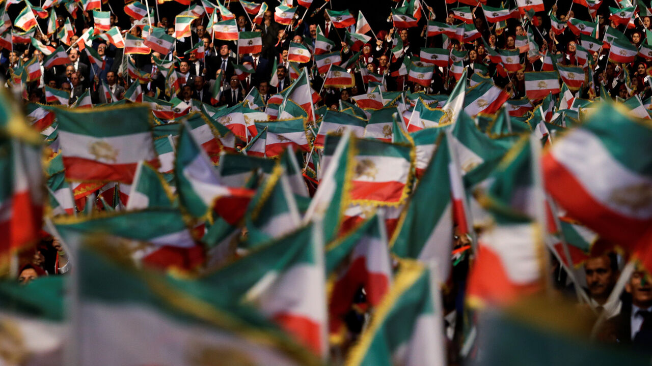 People wave flags during at an event in Ashraf-3 camp, which is a base for the People's Mojahedin Organization of Iran (MEK) in Manza, Albania, July 13, 2019.REUTERS/Florion Goga