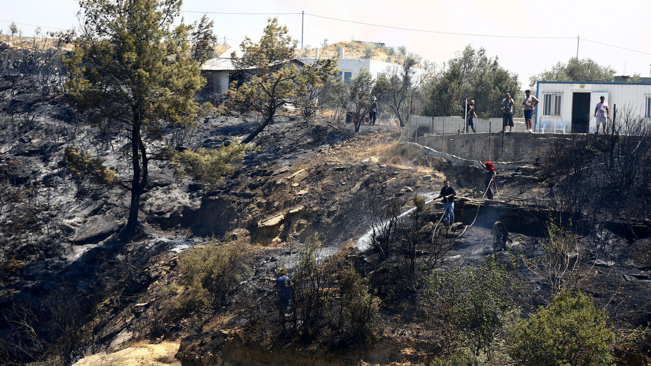 A firefighter works following a wildfire in the Aksu district of Antalya, a Mediterranean city in southern Turkey, July 25, 2025. REUTERS/Kaan Soyturk/File Photo
