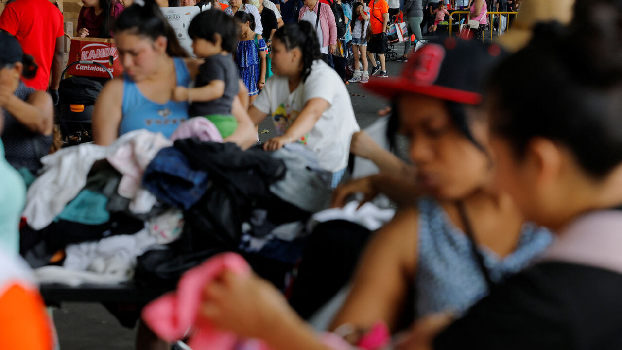 FILE PHOTO: Residents pick up free groceries and clothes at La Colaborativa's food pantry in Chelsea, Massachusetts, U.S., July 1, 2025. REUTERS/Brian Snyder/File Photo