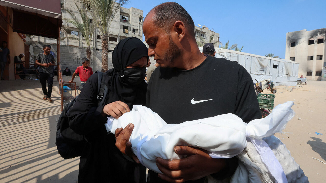 FILE PHOTO: Israa Abu Haleeb and Ahmed Abu Haleeb, the parents of Palestinian baby Zainab Abu Haleeb, who died due to malnutrition, according to health officials, mourn their daughter, in Khan Younis, southern Gaza Strip, July 26, 2025. REUTERS/Ramadan Abed      TPX IMAGES OF THE DAY/File Photo