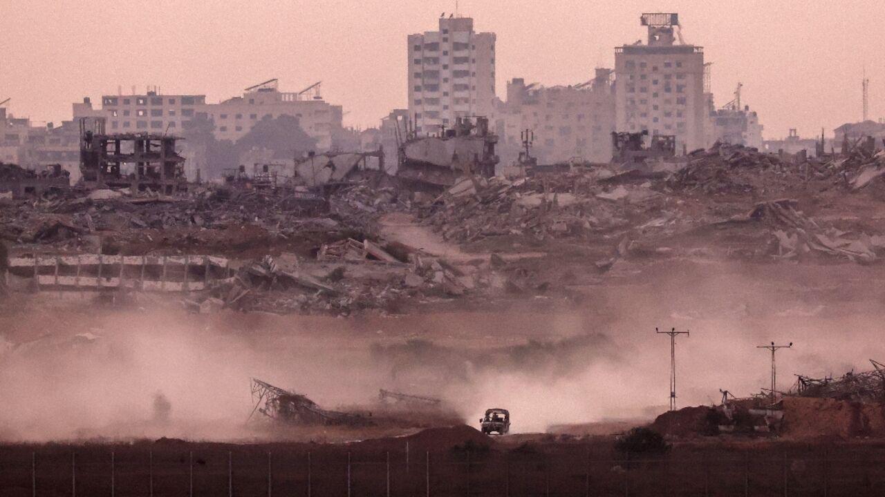 An Israeli military vehicle returning from the Gaza Strip into Israel