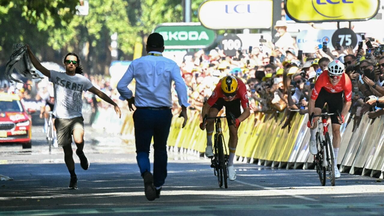 A protestor runs onto the course at the end of the 11th stage of the Tour de France in Toulouse