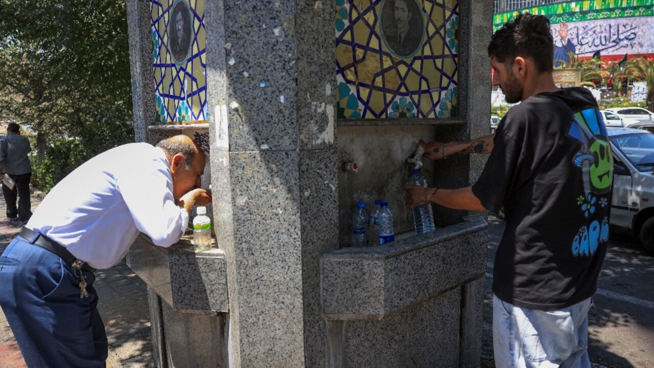 Tehran residents drink from a public fountain as temperatures in the Iranian capital soar.