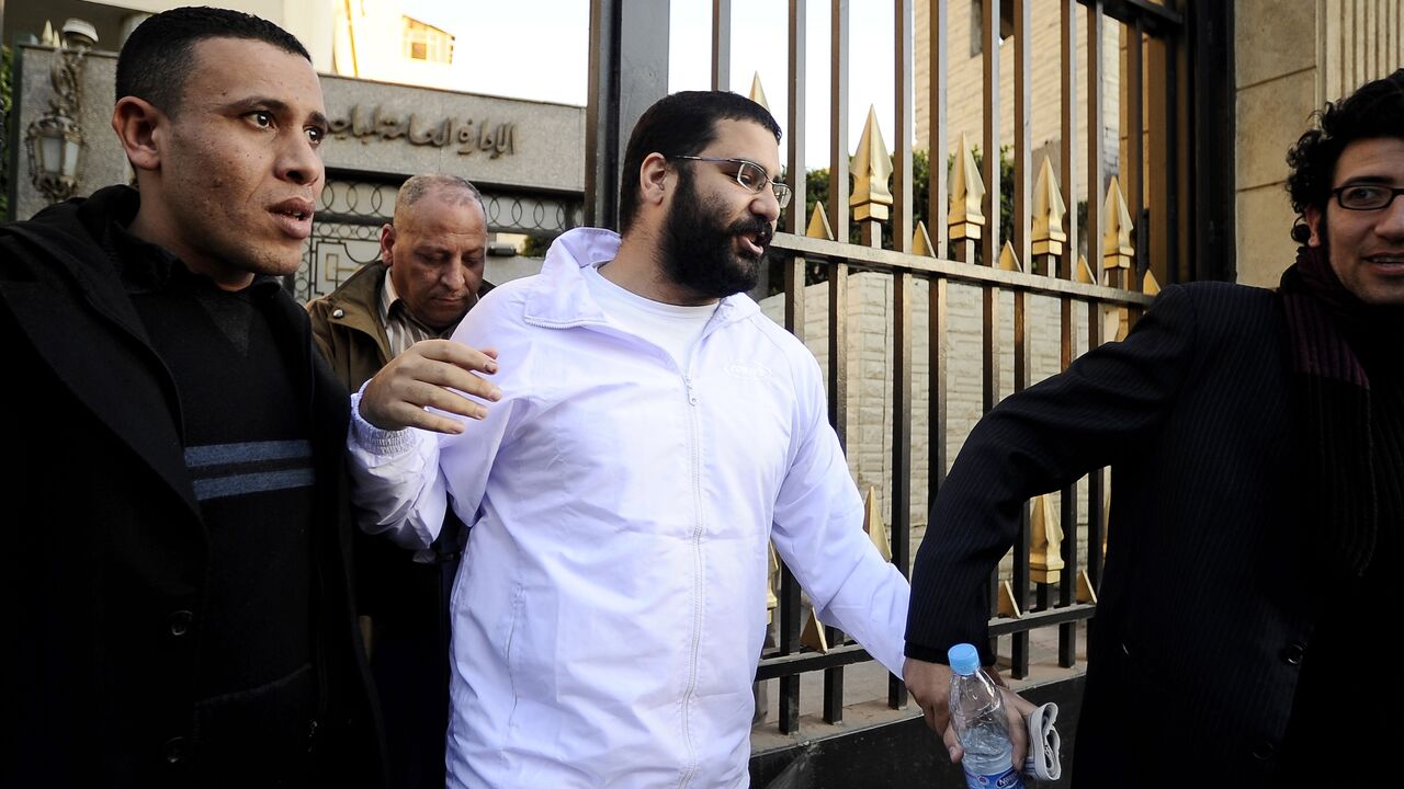 Egyptian blogger and activist Alaa Abdel-Fattah exits the police headquarters in Cairo following his release on December 25, 2011.