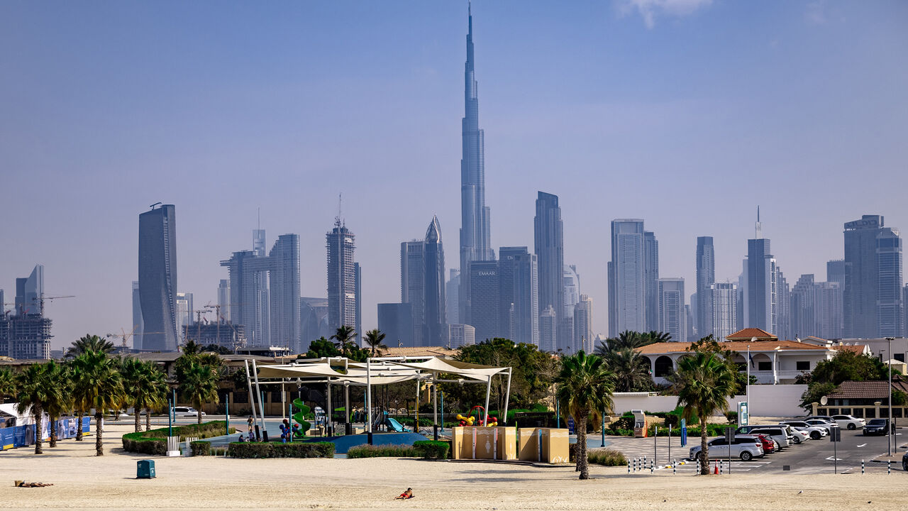 Burj Khalifa, the world's tallest building, adorns the Dubai skyline as people sunbathe on Jumerah beach, Dubai, United Arab Emirates, Jan. 30, 2025.